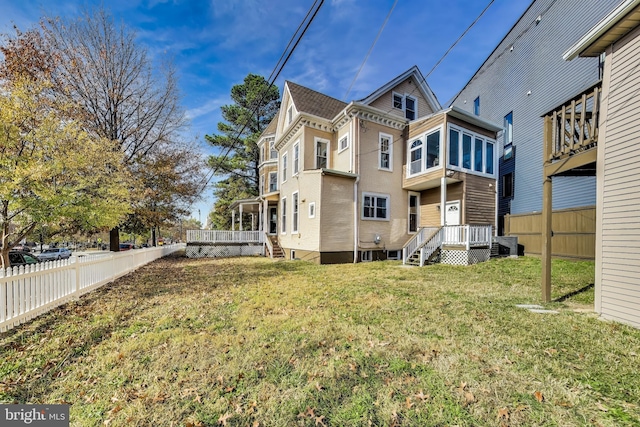 back of property featuring a lawn