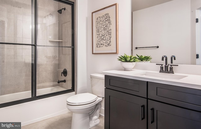 full bathroom featuring tile patterned flooring, vanity, enclosed tub / shower combo, and toilet