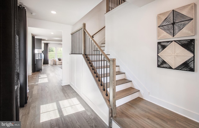 stairs featuring wood-type flooring