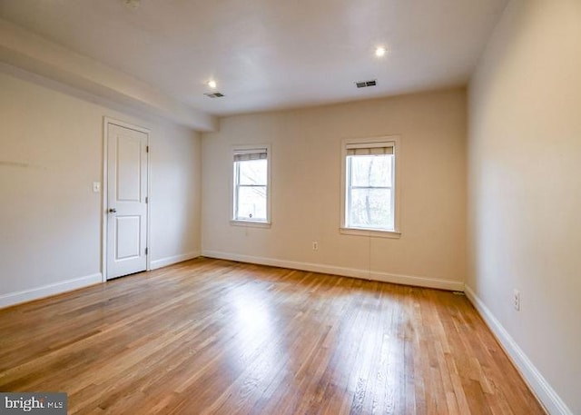 spare room featuring light hardwood / wood-style flooring