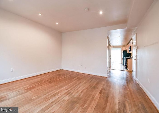 spare room with light hardwood / wood-style floors