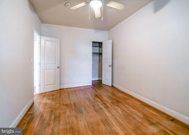 unfurnished bedroom with ceiling fan and hardwood / wood-style flooring