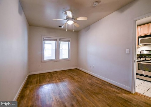 unfurnished room with ceiling fan and light hardwood / wood-style floors