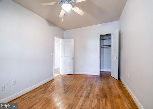 unfurnished bedroom with hardwood / wood-style floors, a closet, and ceiling fan