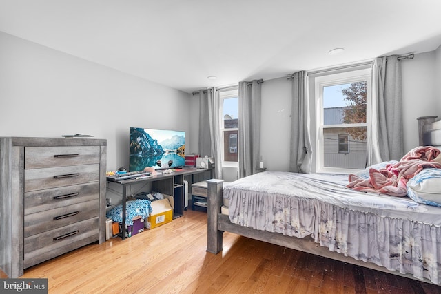 bedroom with hardwood / wood-style flooring