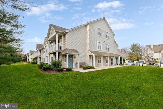 view of property exterior with a lawn and a balcony