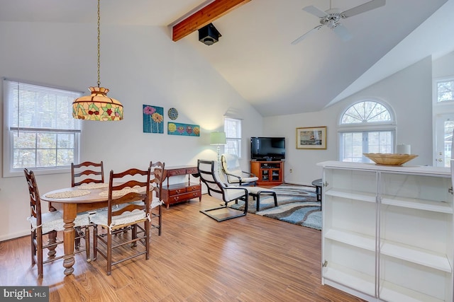 dining room with a wealth of natural light, beamed ceiling, high vaulted ceiling, and light wood-type flooring