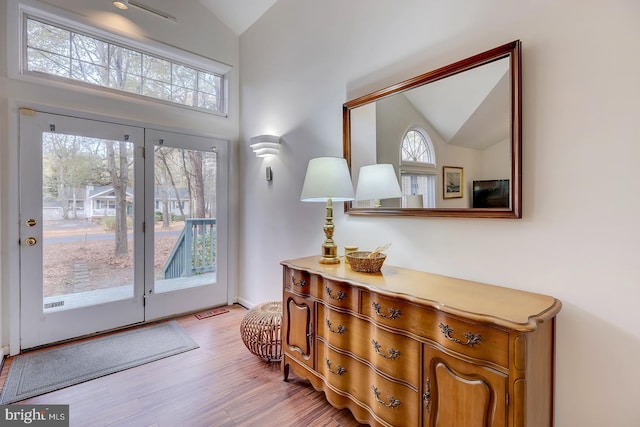 entryway featuring light hardwood / wood-style floors and vaulted ceiling