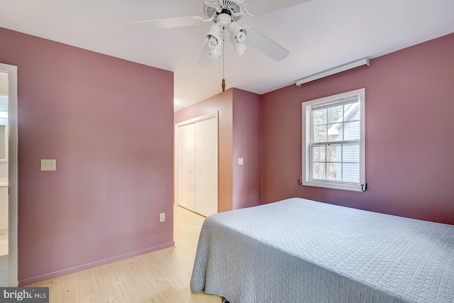 unfurnished bedroom featuring ceiling fan, light hardwood / wood-style floors, and a closet