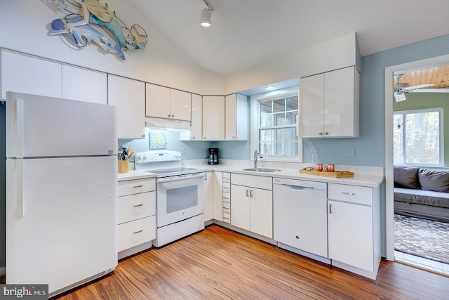 kitchen featuring lofted ceiling, white appliances, white cabinets, sink, and light hardwood / wood-style floors