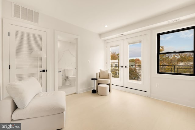 sitting room with a wealth of natural light and french doors