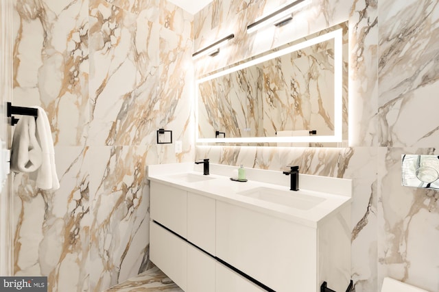 bathroom featuring vanity and tile walls