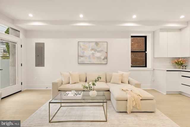 living room with electric panel and light hardwood / wood-style floors