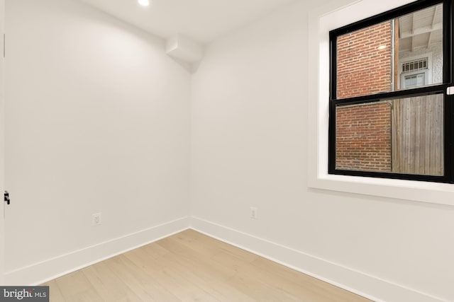 unfurnished room featuring hardwood / wood-style flooring