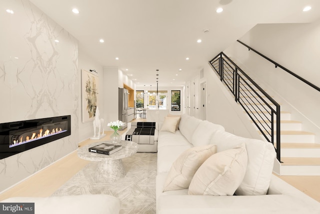 living room featuring light hardwood / wood-style floors and a tile fireplace