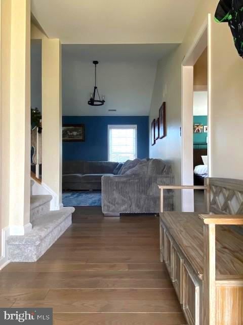 interior space with wood-type flooring and vaulted ceiling