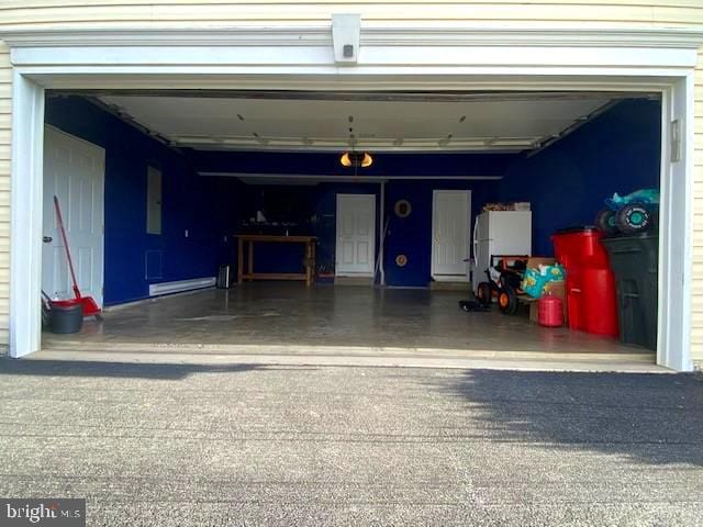 garage featuring white refrigerator and electric panel