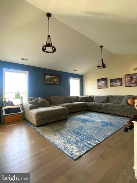 unfurnished living room with lofted ceiling and hardwood / wood-style floors