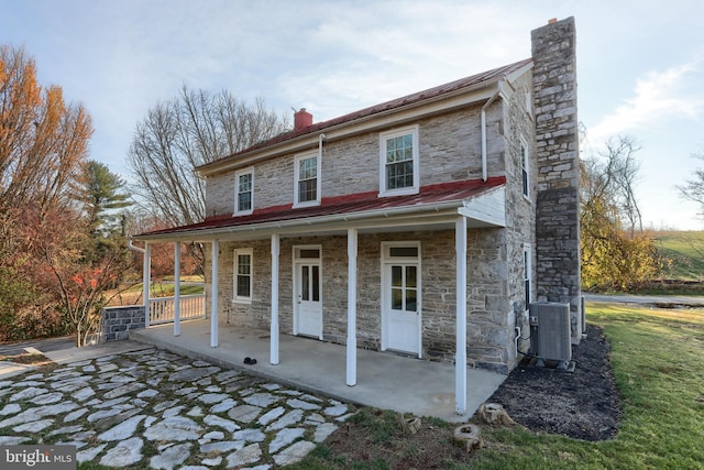 view of front of home with covered porch and central air condition unit