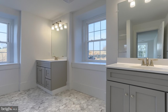 bathroom with tile patterned floors, plenty of natural light, and vanity