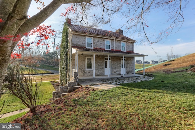 view of front of house with covered porch and a front yard