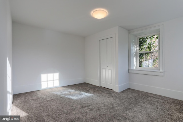 unfurnished bedroom with a closet and carpet