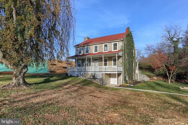 view of front of home featuring a front yard and a porch