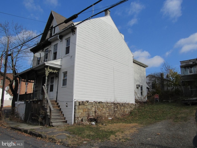 view of side of home with covered porch