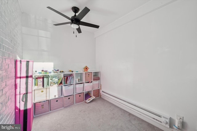 recreation room featuring light colored carpet, ceiling fan, and a baseboard heating unit