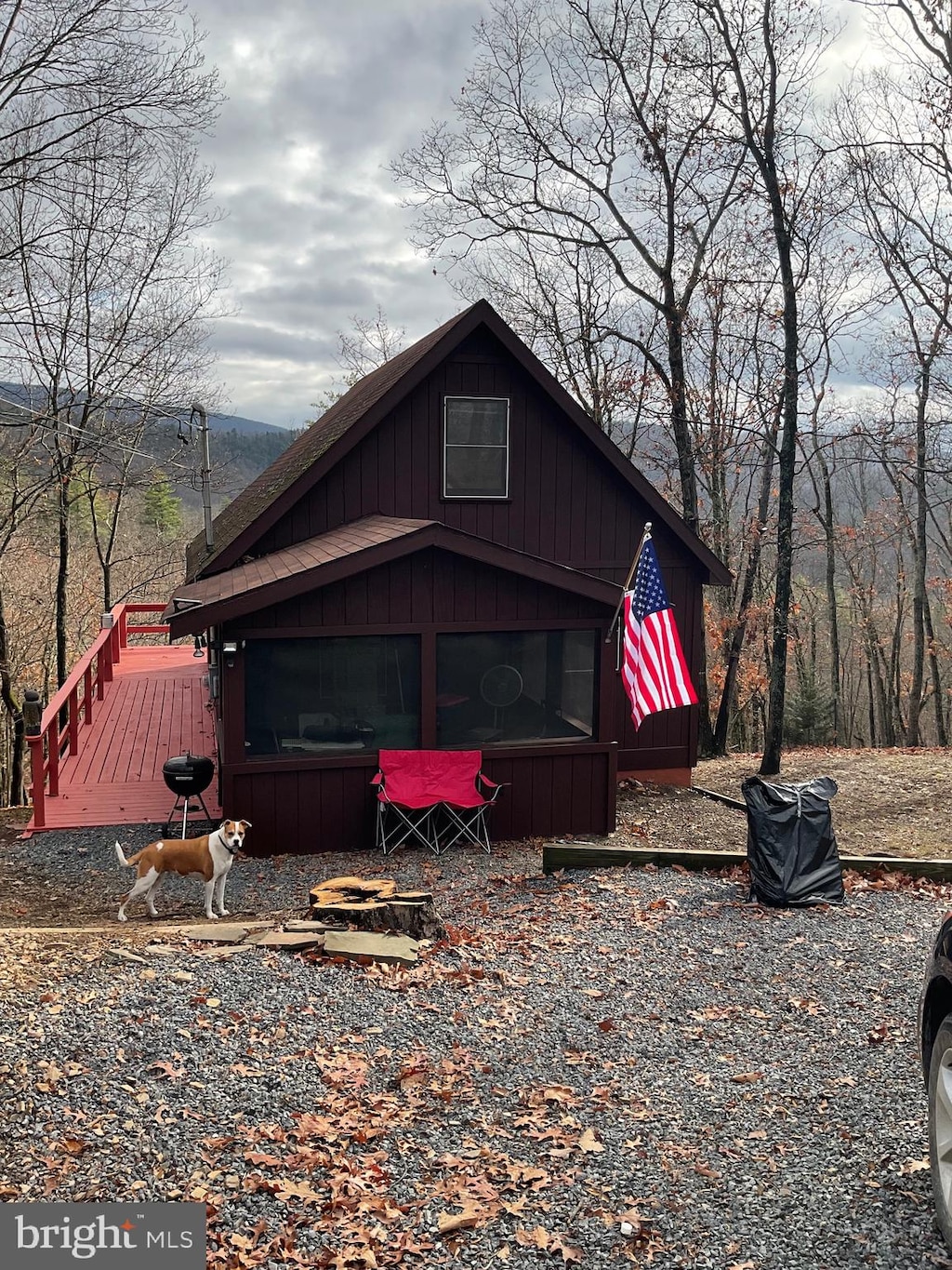 rear view of property featuring a wooden deck