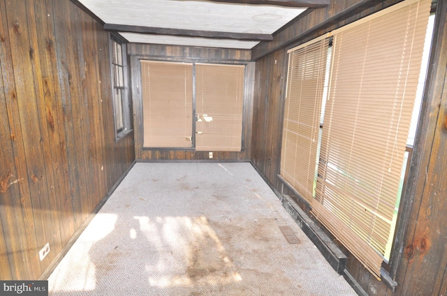 interior space with wood walls and light colored carpet