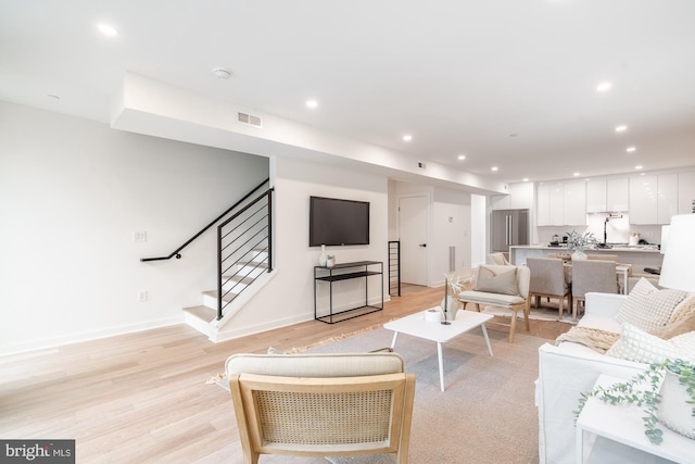 living room with light hardwood / wood-style flooring