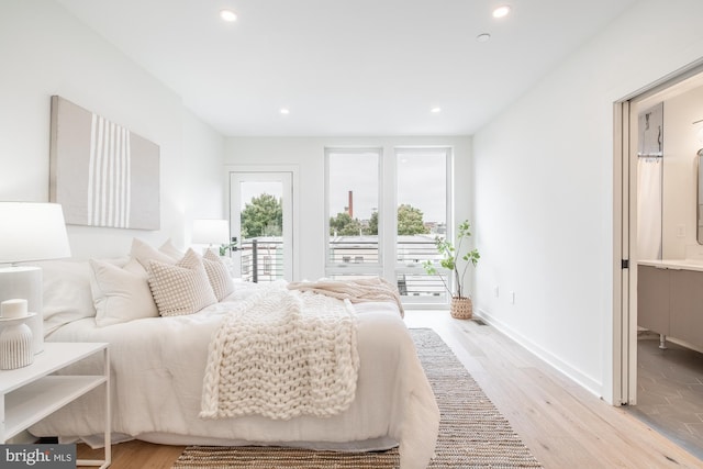 bedroom with access to exterior and light wood-type flooring