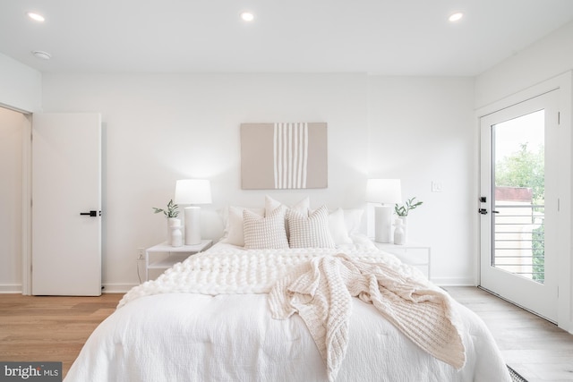 bedroom with access to exterior and light wood-type flooring