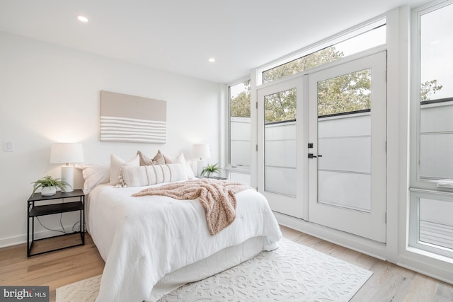 bedroom with light hardwood / wood-style floors and access to outside