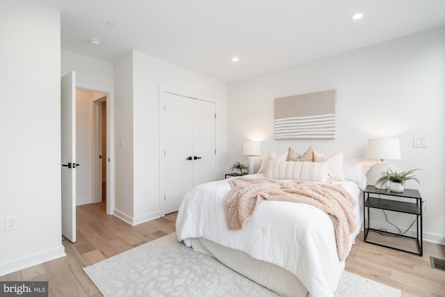 bedroom featuring light hardwood / wood-style flooring and a closet