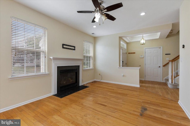 unfurnished living room with ceiling fan, light hardwood / wood-style floors, and a wealth of natural light