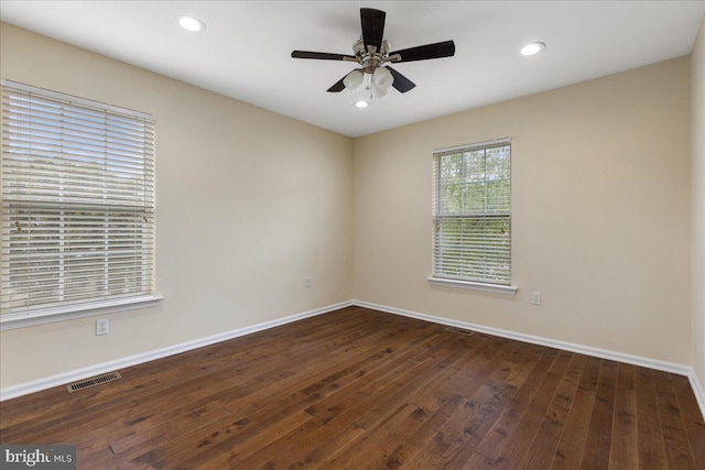 unfurnished room with ceiling fan and dark wood-type flooring