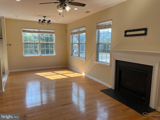 unfurnished living room featuring ceiling fan and light hardwood / wood-style flooring