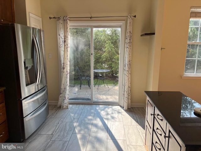 entryway featuring plenty of natural light and light tile patterned flooring