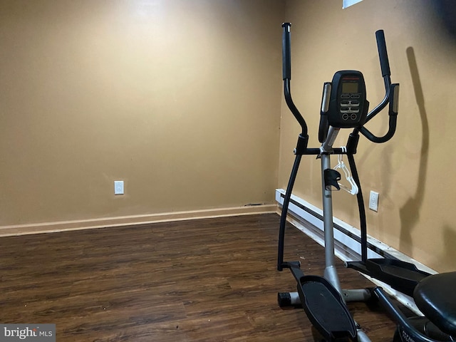 workout area with dark hardwood / wood-style floors