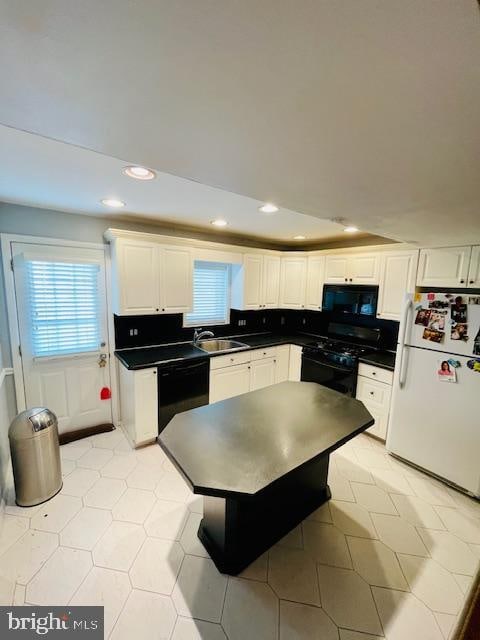 kitchen featuring backsplash, white cabinetry, sink, and black appliances