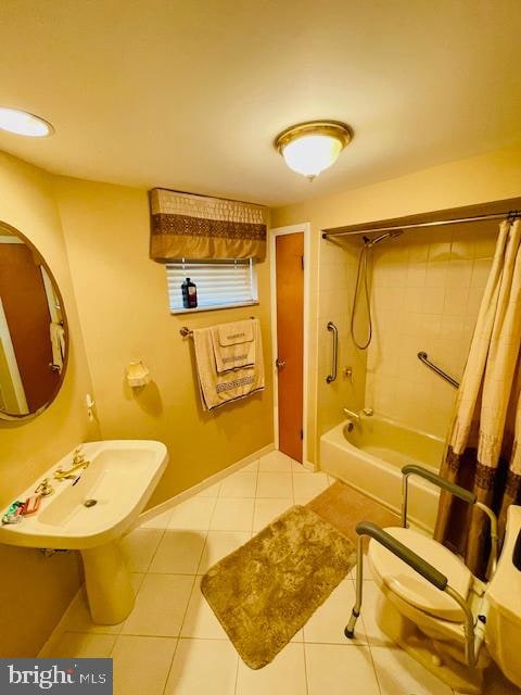 bathroom featuring tile patterned floors and shower / bath combo with shower curtain