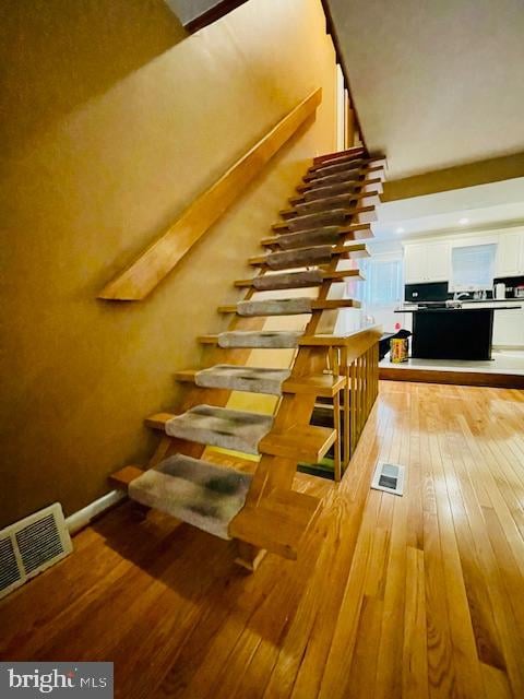 stairs with wood-type flooring