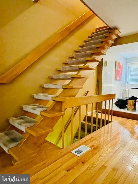 stairway with hardwood / wood-style floors