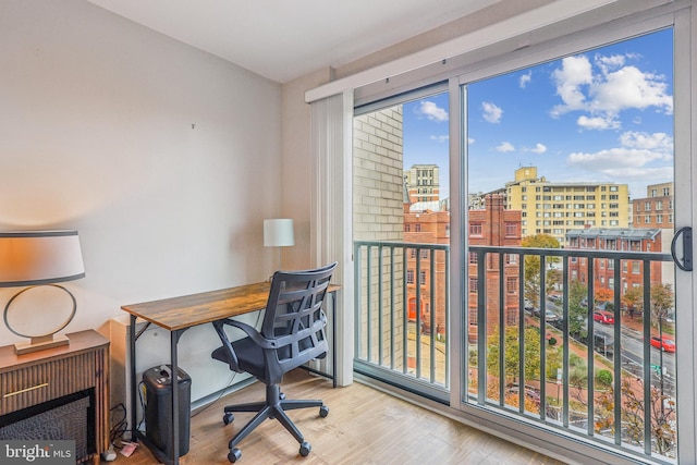 home office with light hardwood / wood-style flooring