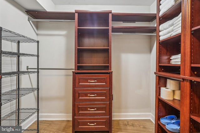 spacious closet featuring hardwood / wood-style floors