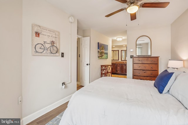 bedroom with ensuite bath, ceiling fan, and wood-type flooring