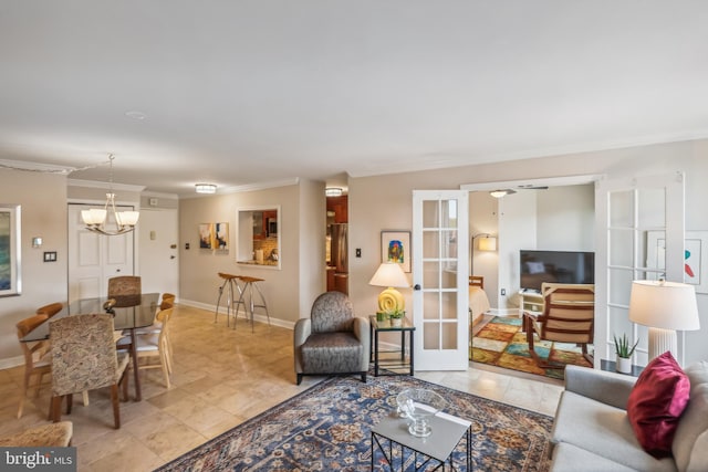 living room featuring french doors, an inviting chandelier, and ornamental molding