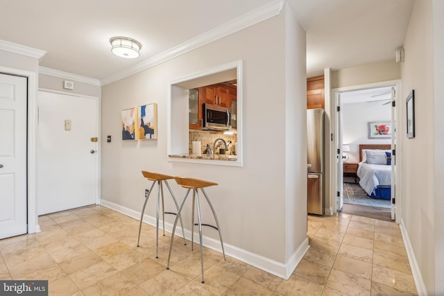 hallway with sink and ornamental molding